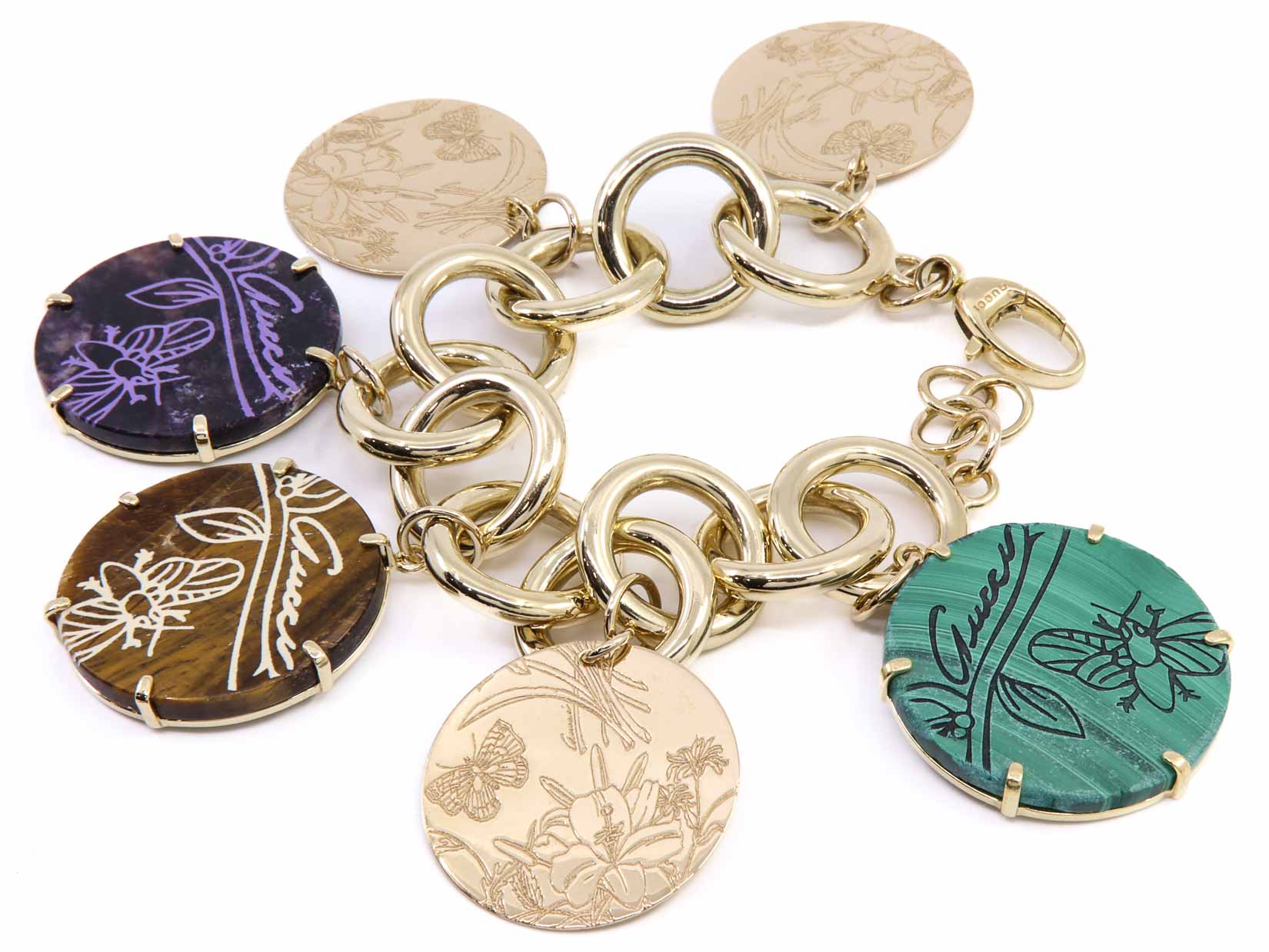 Bracciale in oro 18kt marcato Gucci con ciondoli in oro pietre naturali, per gr. 65,3 (oro netto) ad euro 55,13