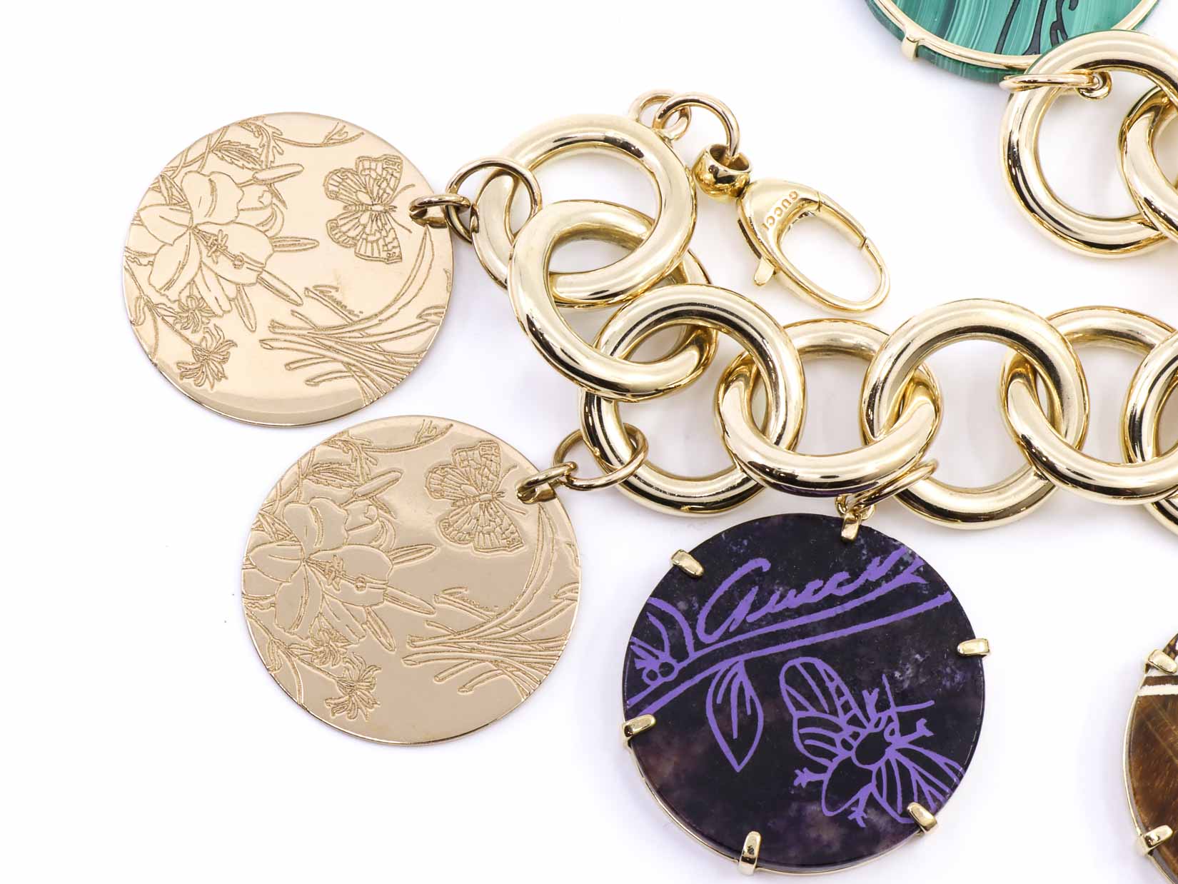 Bracciale in oro 18kt marcato Gucci con ciondoli in oro pietre naturali, per gr. 65,3 (oro netto) ad euro 55,13